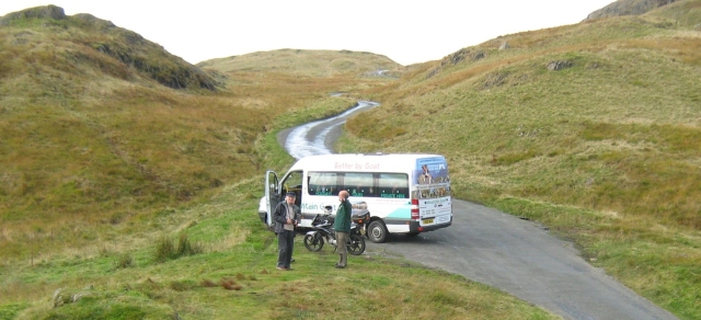 the coach with a couple of tourists at the top of the hardknott pass